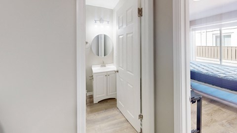 A white door with a mirror above it.
